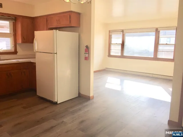 a white refrigerator freezer and a stove sitting inside of a kitchen