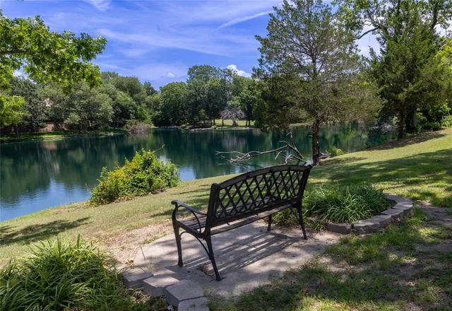 a view of a lake with a bench and lake view