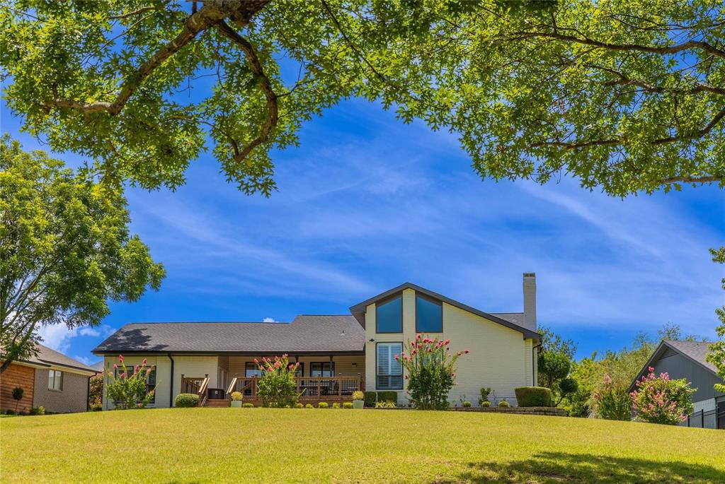 224 Sovereign Court Rockwall, TX 75032 - Photo 3 of 16 a front view of a house with a yard