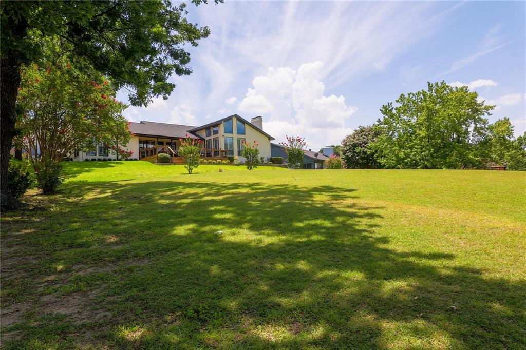 224 Sovereign Court Rockwall, TX 75032 - Photo 4 of 16 a view of a house with a big yard
