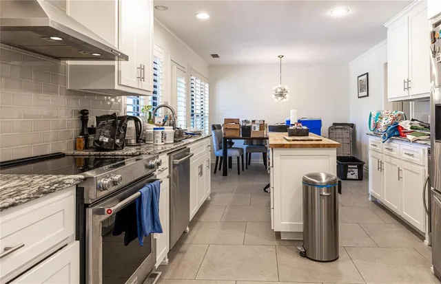 a kitchen that has a lot of cabinets in it and appliances