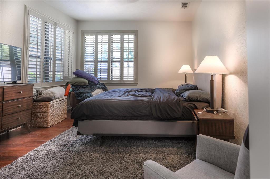 224 Sovereign Court Rockwall, TX 75032 - Photo 9 of 16 a spacious bedroom with a bed and a couch