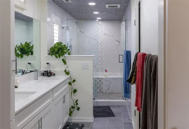 a bathroom with a sink a mirror and a shower