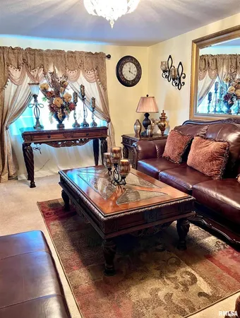 a dining room with furniture a chandelier and a rug