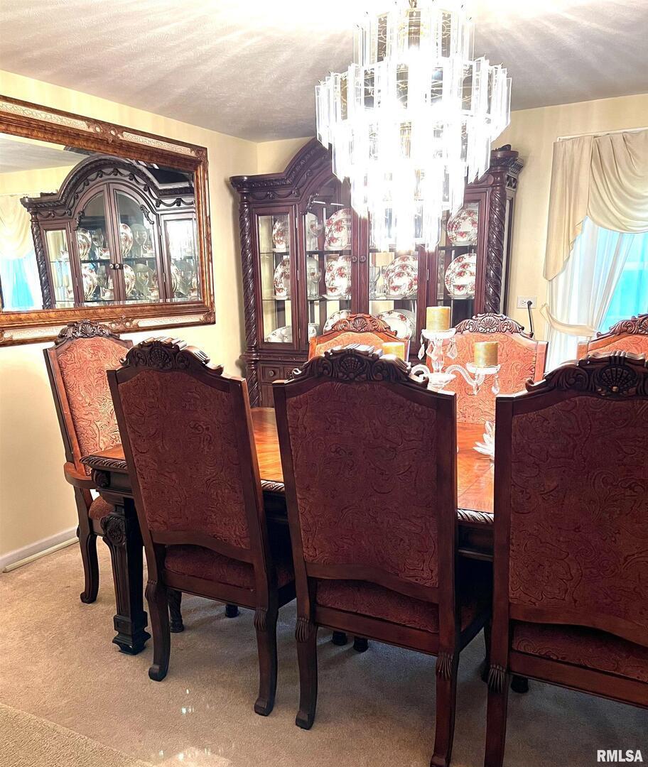 550 South Vienna Road Olmsted, IL 62970 - Photo 27 of 31 a dining room with furniture a chandelier and a rug