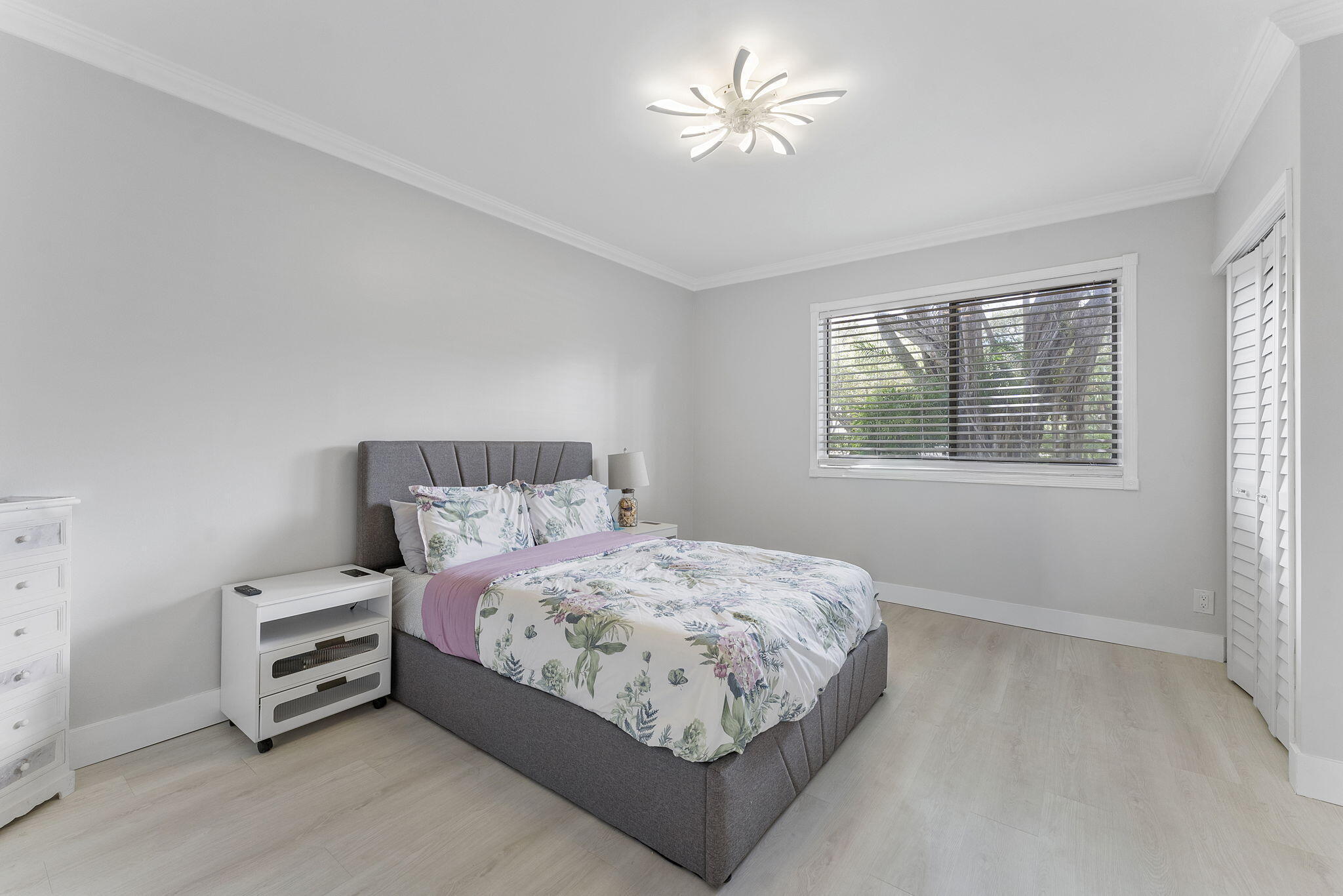 6314 Longboat Lane West, Unit A102 Boca Raton, FL 33433 - Photo 18 of 24 a bedroom with a bed and a chandelier