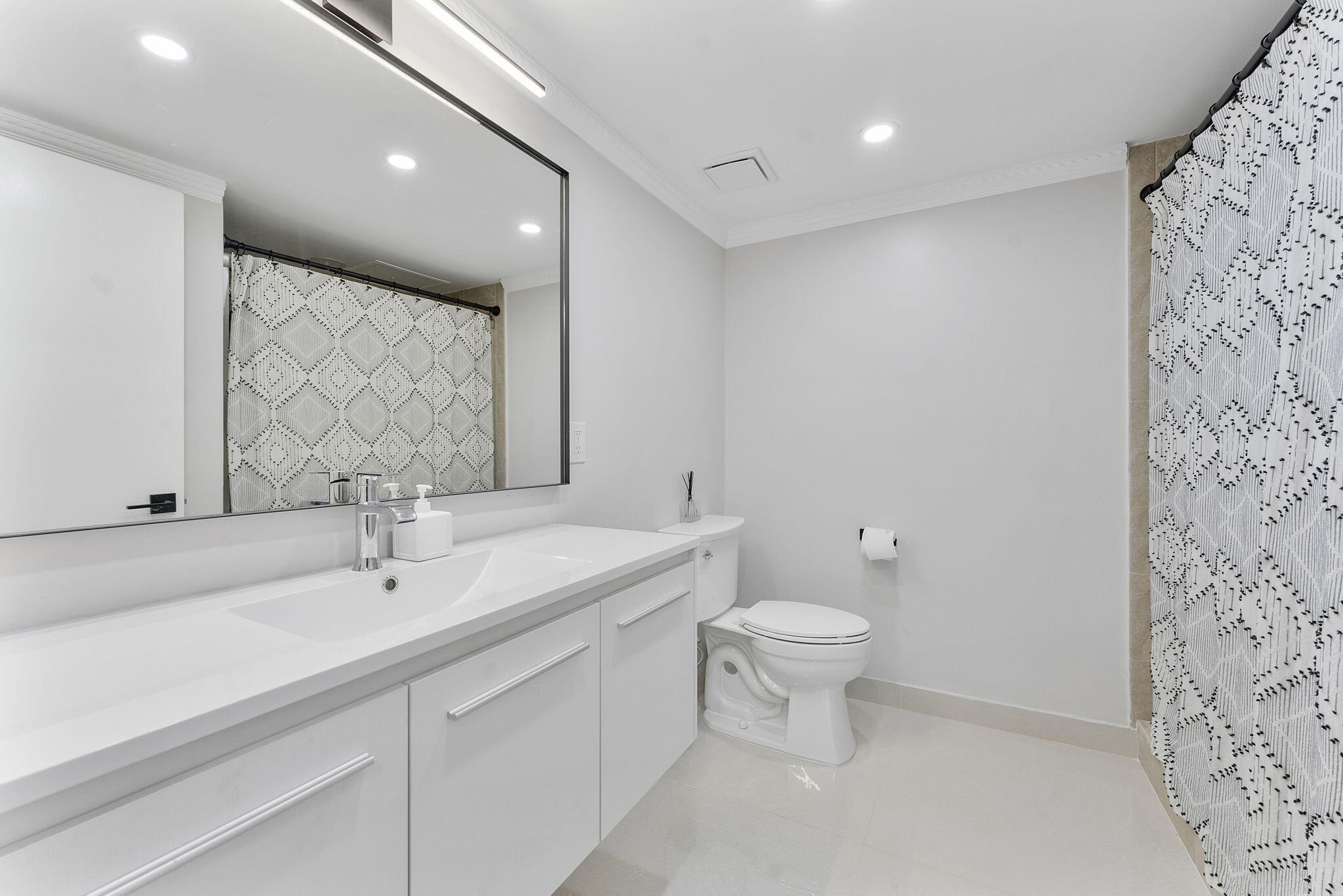 6314 Longboat Lane West, Unit A102 Boca Raton, FL 33433 - Photo 20 of 24 a bathroom with a toilet sink and mirror