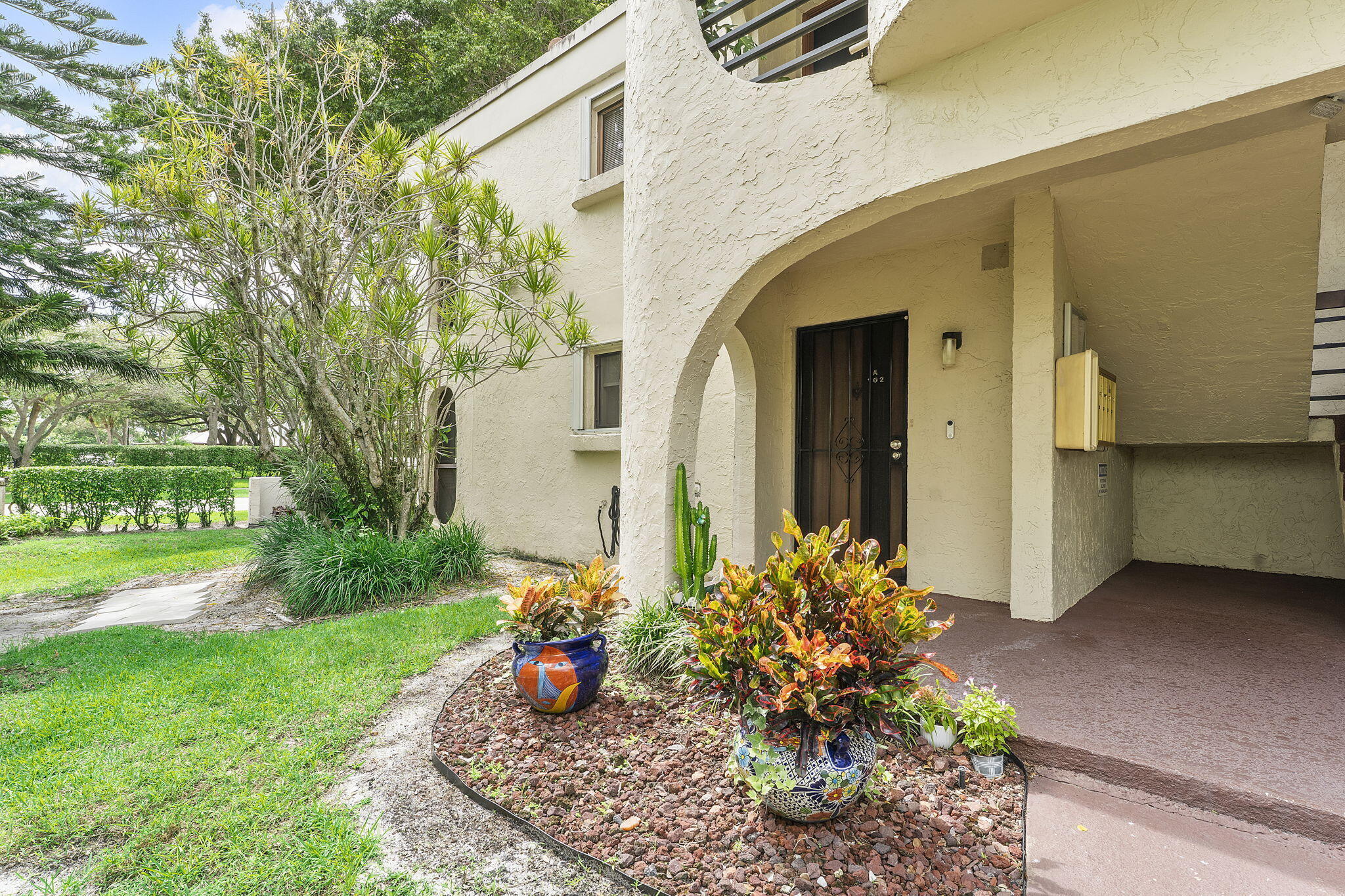 6314 Longboat Lane West, Unit A102 Boca Raton, FL 33433 - Photo 2 of 24 a view of a house with a garden