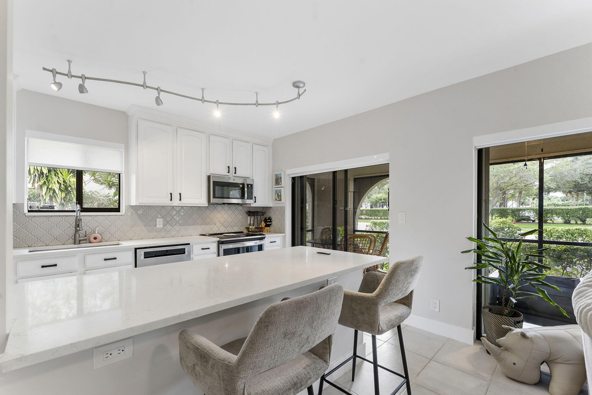 6314 Longboat Lane West, Unit A102 Boca Raton, FL 33433 - Photo 6 of 24 a kitchen with stainless steel appliances granite countertop a refrigerator sink and cabinets