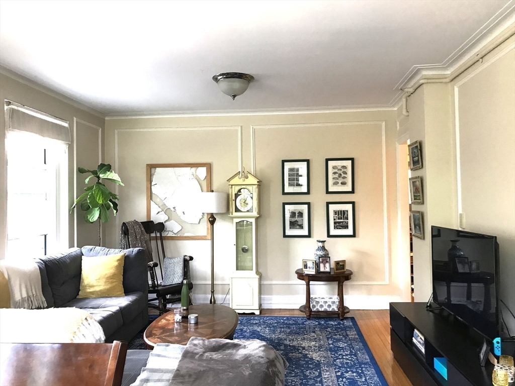 1450 Beacon Street, Unit 342 Brookline, MA 02446 - Photo 12 of 16 a living room with furniture a flat screen tv and a window