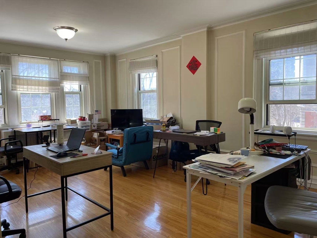 1450 Beacon Street, Unit 342 Brookline, MA 02446 - Photo 2 of 16 a living room with furniture and a wooden floor