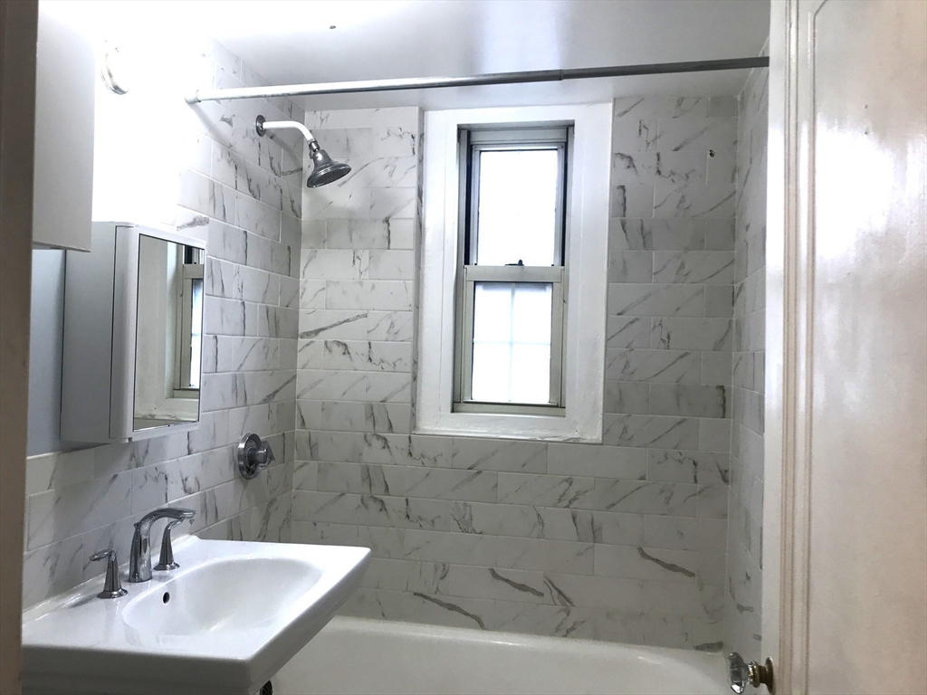 1450 Beacon Street, Unit 342 Brookline, MA 02446 - Photo 6 of 16 a bathroom with a shower and a sink