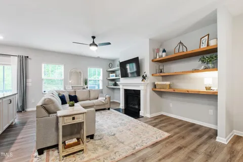 a living room with furniture fireplace and window