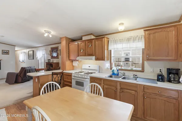 a kitchen with a table chairs stove and cabinets