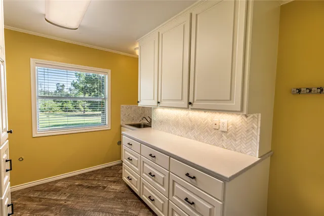 a bathroom with a sink and a window