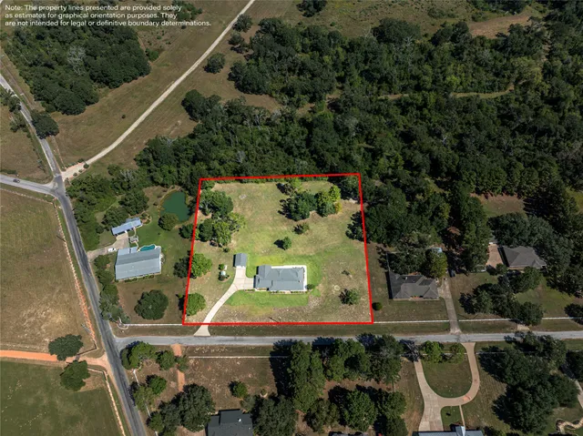 an aerial view of a house with outdoor space