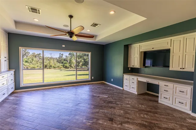 a view of a kitchen with microwave and cabinets
