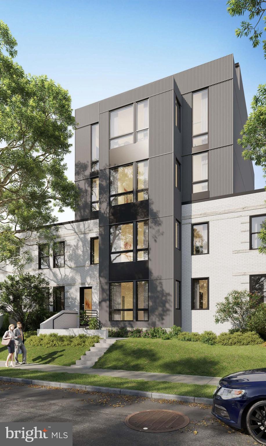 a front view of a residential apartment building with a yard