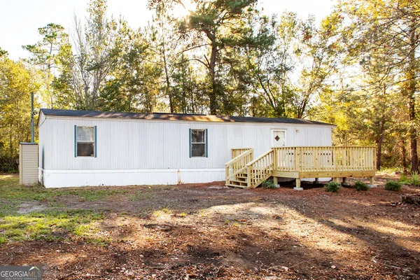 a view of a house with a backyard