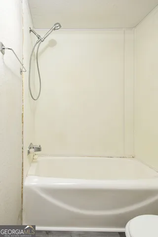 a bathroom with a shower and a bath tub