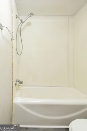 a bathroom with a shower and a bath tub