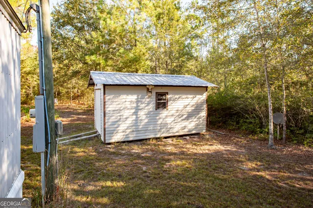 a view of a house with a tree beside it