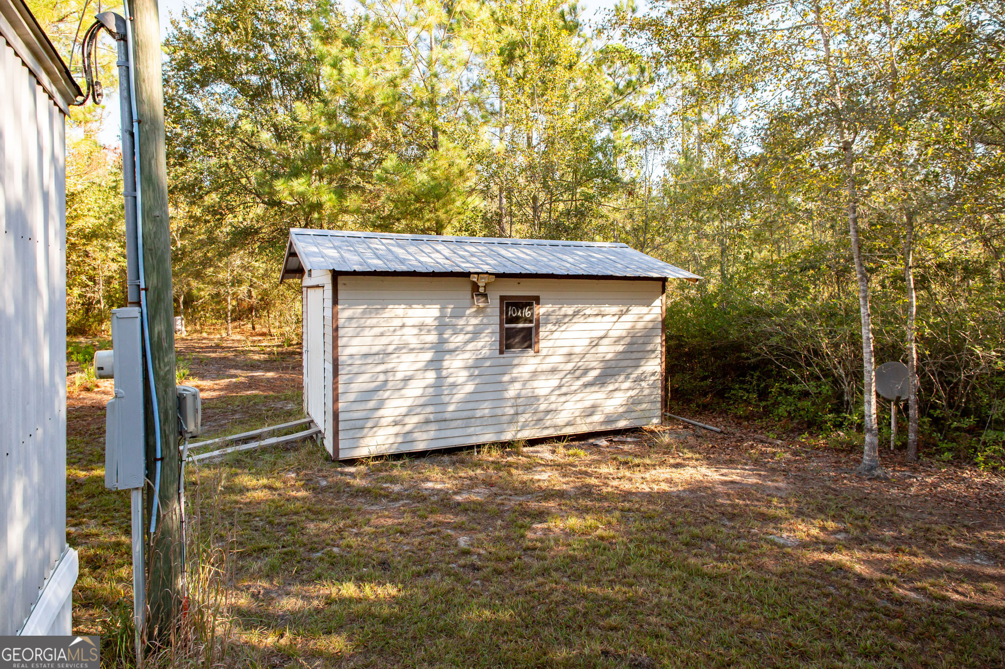 6005 Chancey Road Patterson, GA 31557 - Photo 21 of 23 a view of a house with a tree beside it
