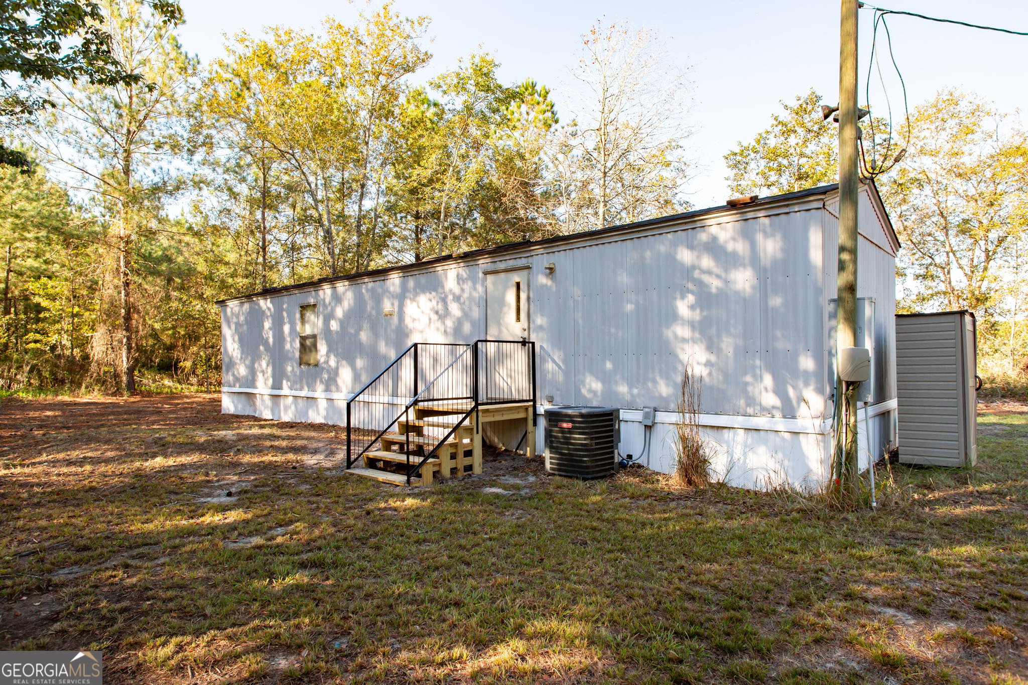 6005 Chancey Road Patterson, GA 31557 - Photo 4 of 23 a backyard of a house with table and chairs