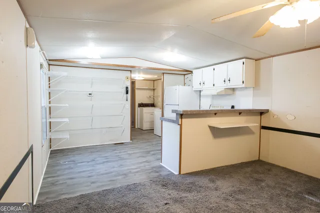a utility room with cabinets washer and dryer