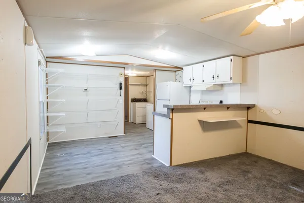 a utility room with cabinets washer and dryer