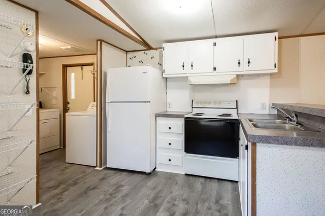 a kitchen with stainless steel appliances a refrigerator sink and cabinets