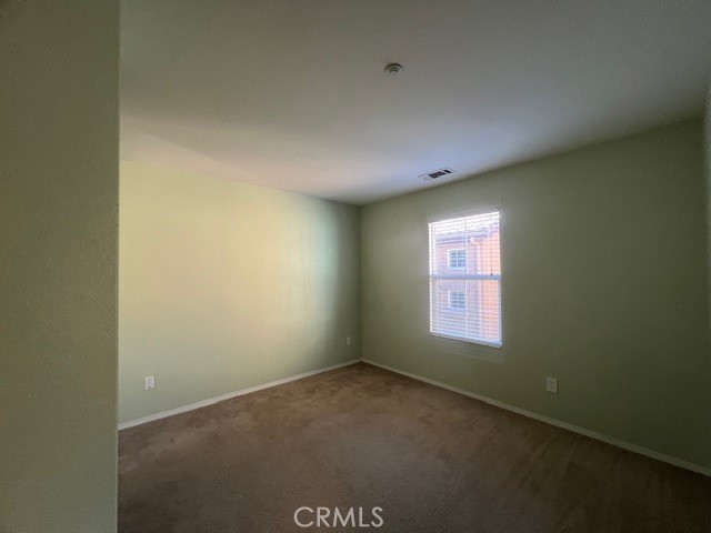 10375 Church Street, Unit 106 Rancho Cucamonga, CA 91730 - Photo 14 of 26 an empty room with a window