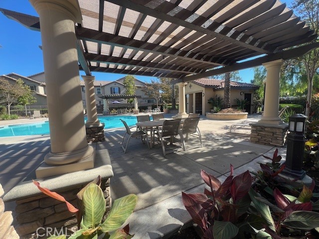 10375 Church Street, Unit 106 Rancho Cucamonga, CA 91730 - Photo 22 of 26 a view of a patio with table and chairs with plants and wooden floor