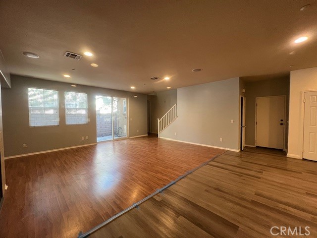 10375 Church Street, Unit 106 Rancho Cucamonga, CA 91730 - Photo 5 of 26 an empty room with wooden floor and windows