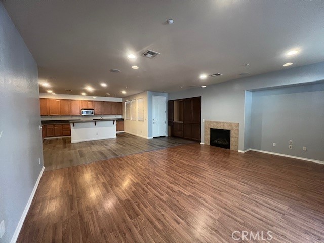 10375 Church Street, Unit 106 Rancho Cucamonga, CA 91730 - Photo 6 of 26 a view of kitchen and hall with wooden floor