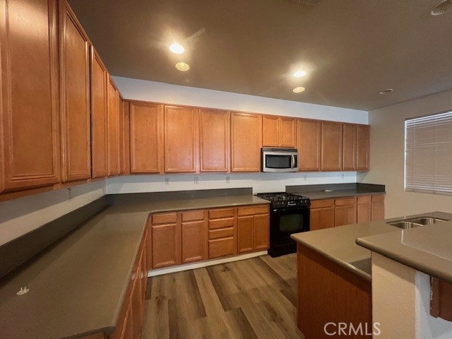 10375 Church Street, Unit 106 Rancho Cucamonga, CA 91730 - Photo 7 of 26 a kitchen with stainless steel appliances granite countertop a sink stove refrigerator and cabinets