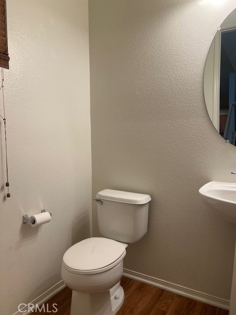 10375 Church Street, Unit 106 Rancho Cucamonga, CA 91730 - Photo 9 of 26 a white toilet sitting next to a white wall