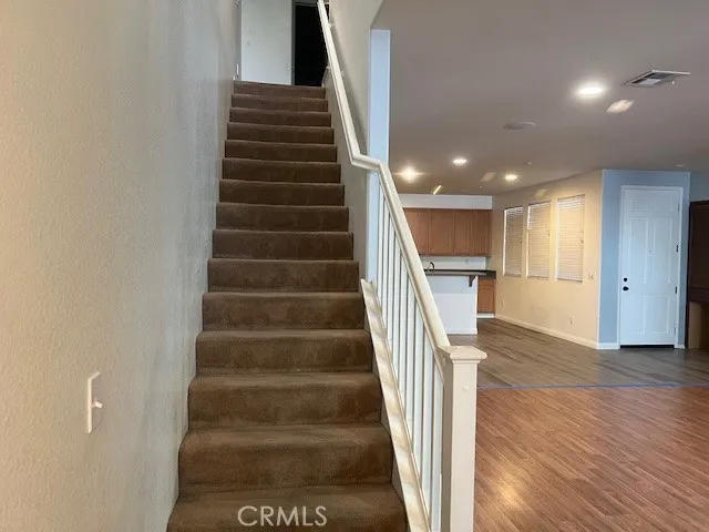a view of entryway and hall with wooden floor