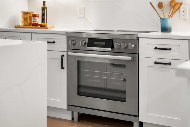 a close view of a stove and microwave in a kitchen