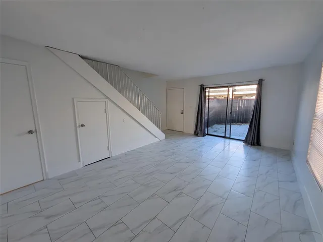 a view of an empty room with a fireplace