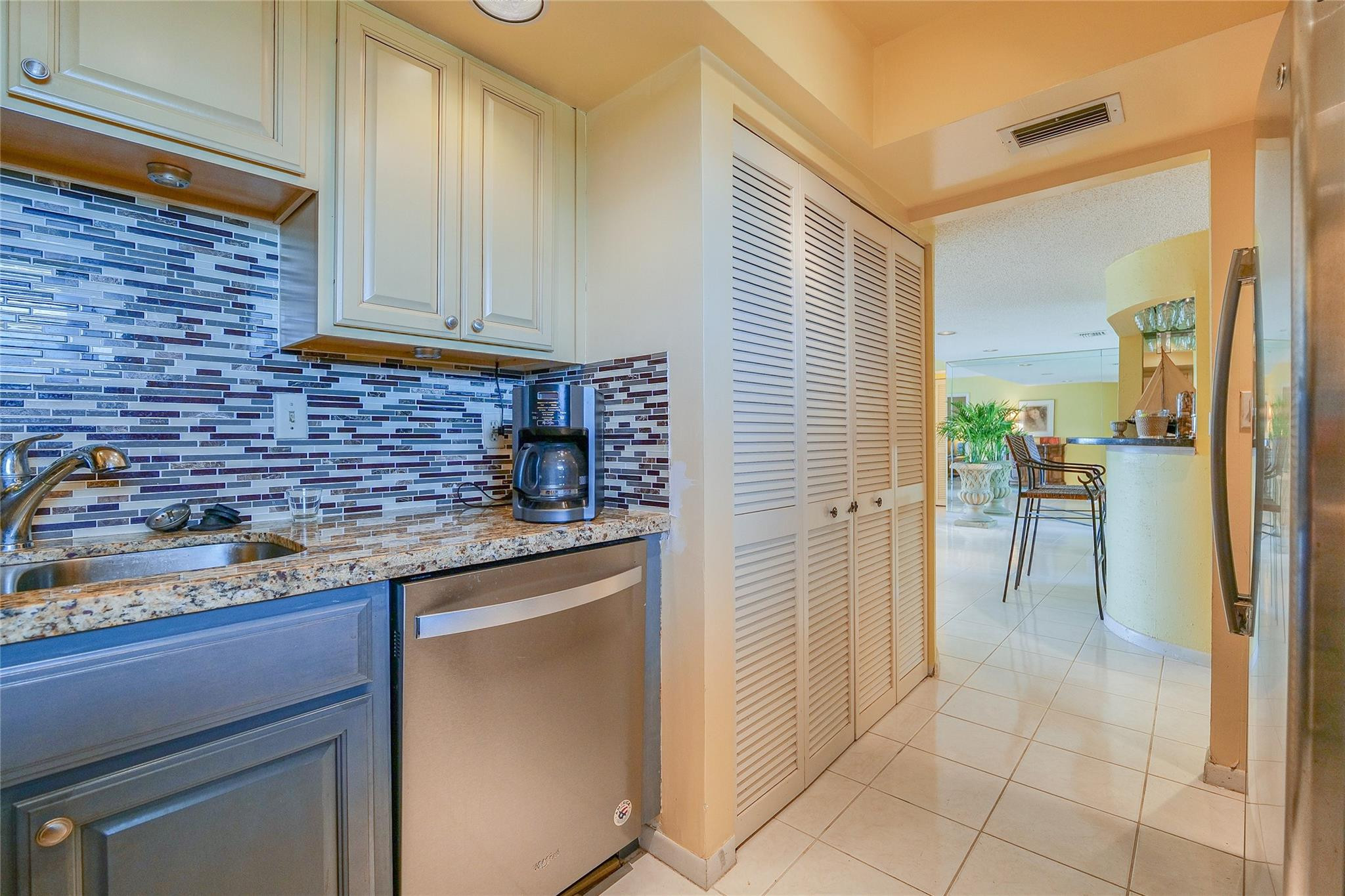 3930 Inverrary Boulevard, Unit 608D Lauderhill, FL 33319 - Photo 19 of 65 a kitchen with stainless steel appliances granite countertop a refrigerator and a sink