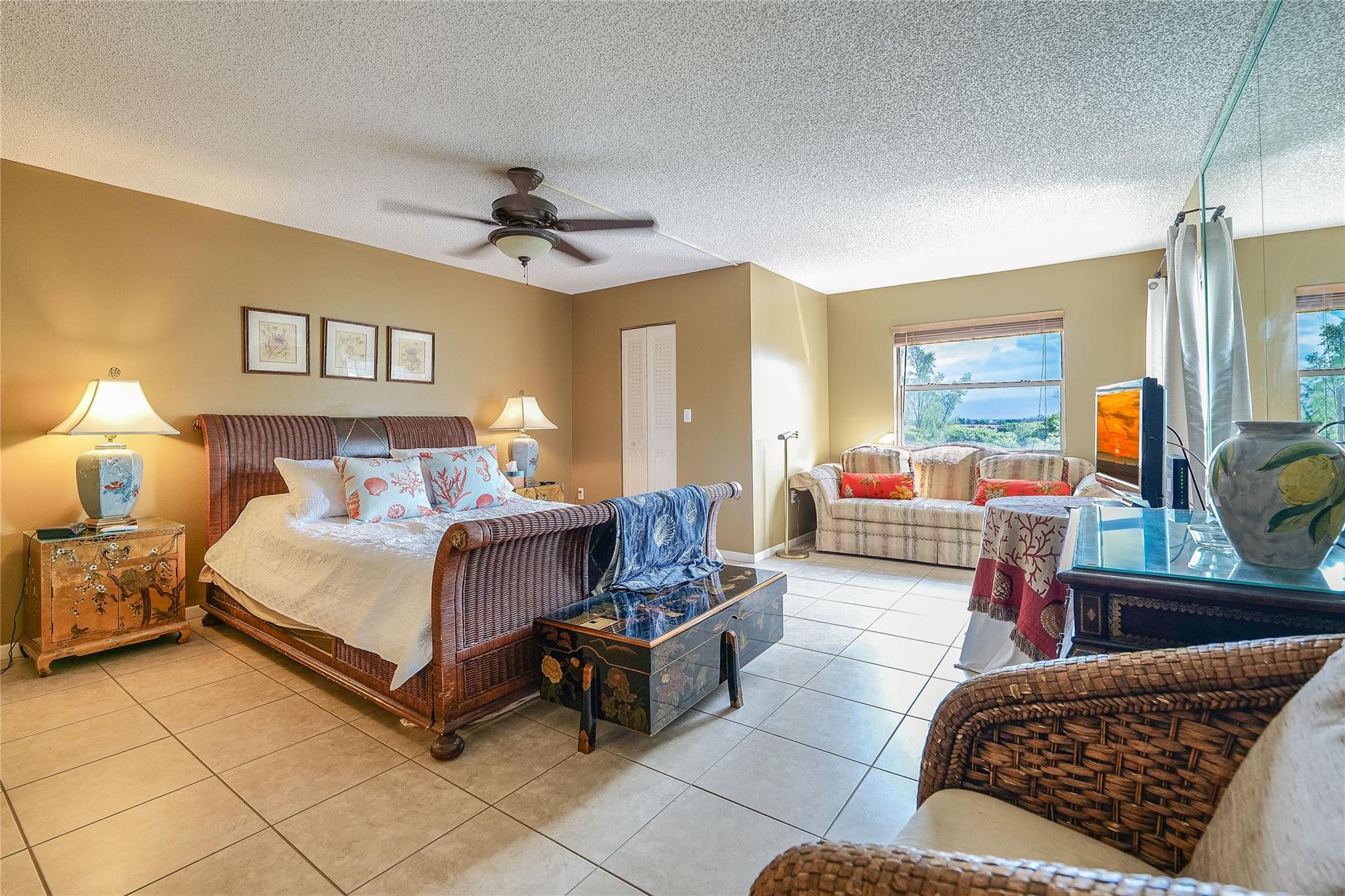 3930 Inverrary Boulevard, Unit 608D Lauderhill, FL 33319 - Photo 20 of 65 a bedroom with a bed couch and window