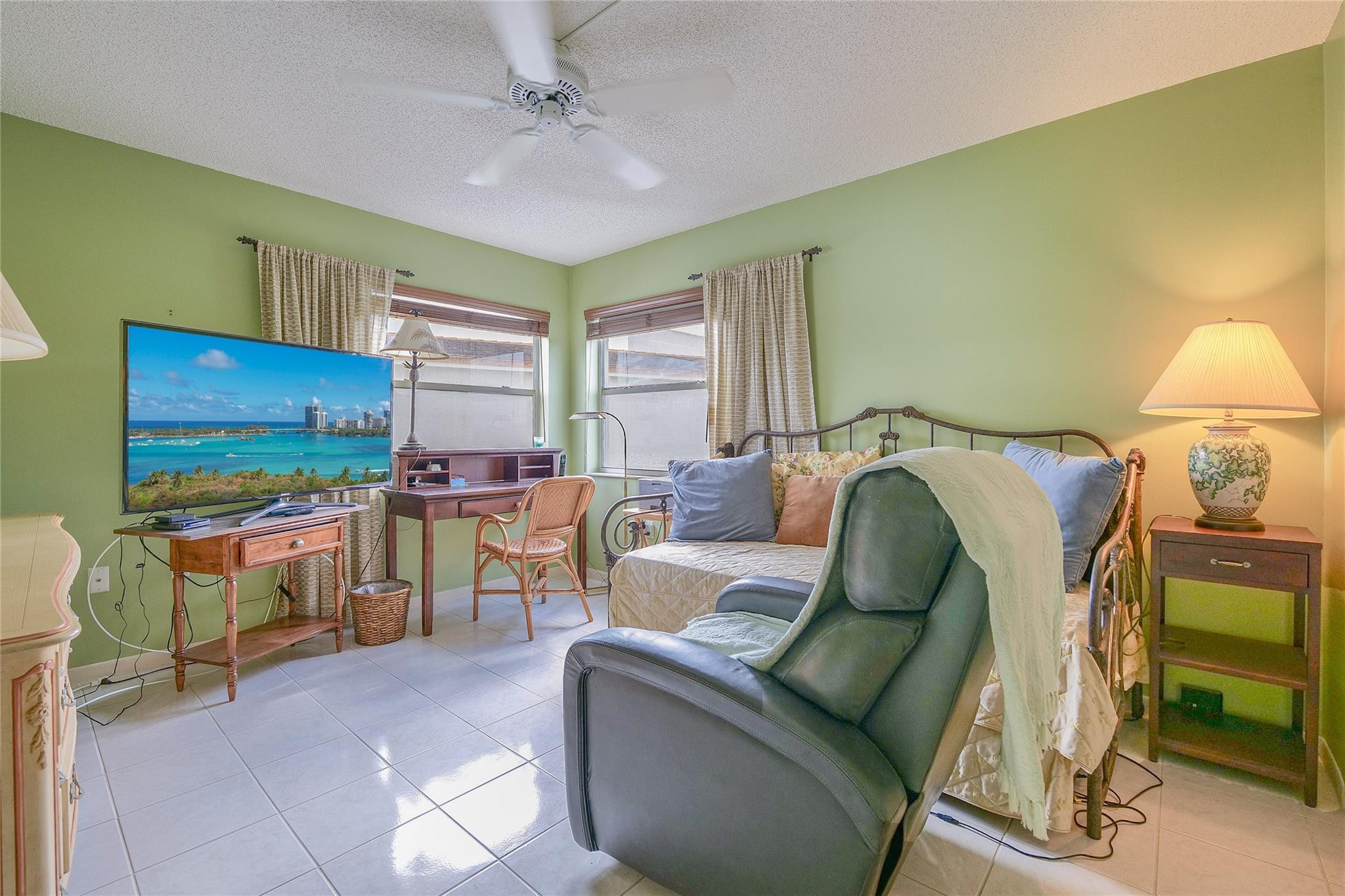 3930 Inverrary Boulevard, Unit 608D Lauderhill, FL 33319 - Photo 26 of 65 a living room with furniture and a flat screen tv
