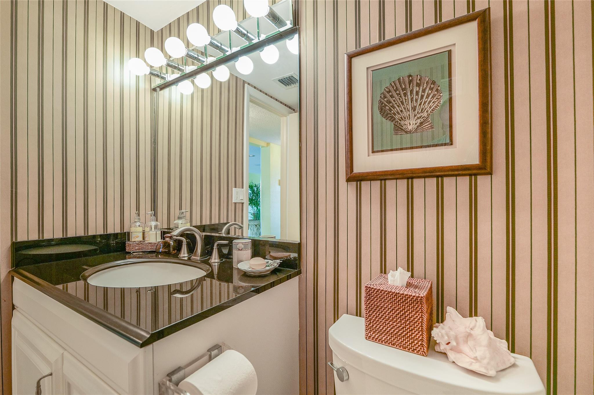 3930 Inverrary Boulevard, Unit 608D Lauderhill, FL 33319 - Photo 29 of 65 a bathroom with a sink and a mirror