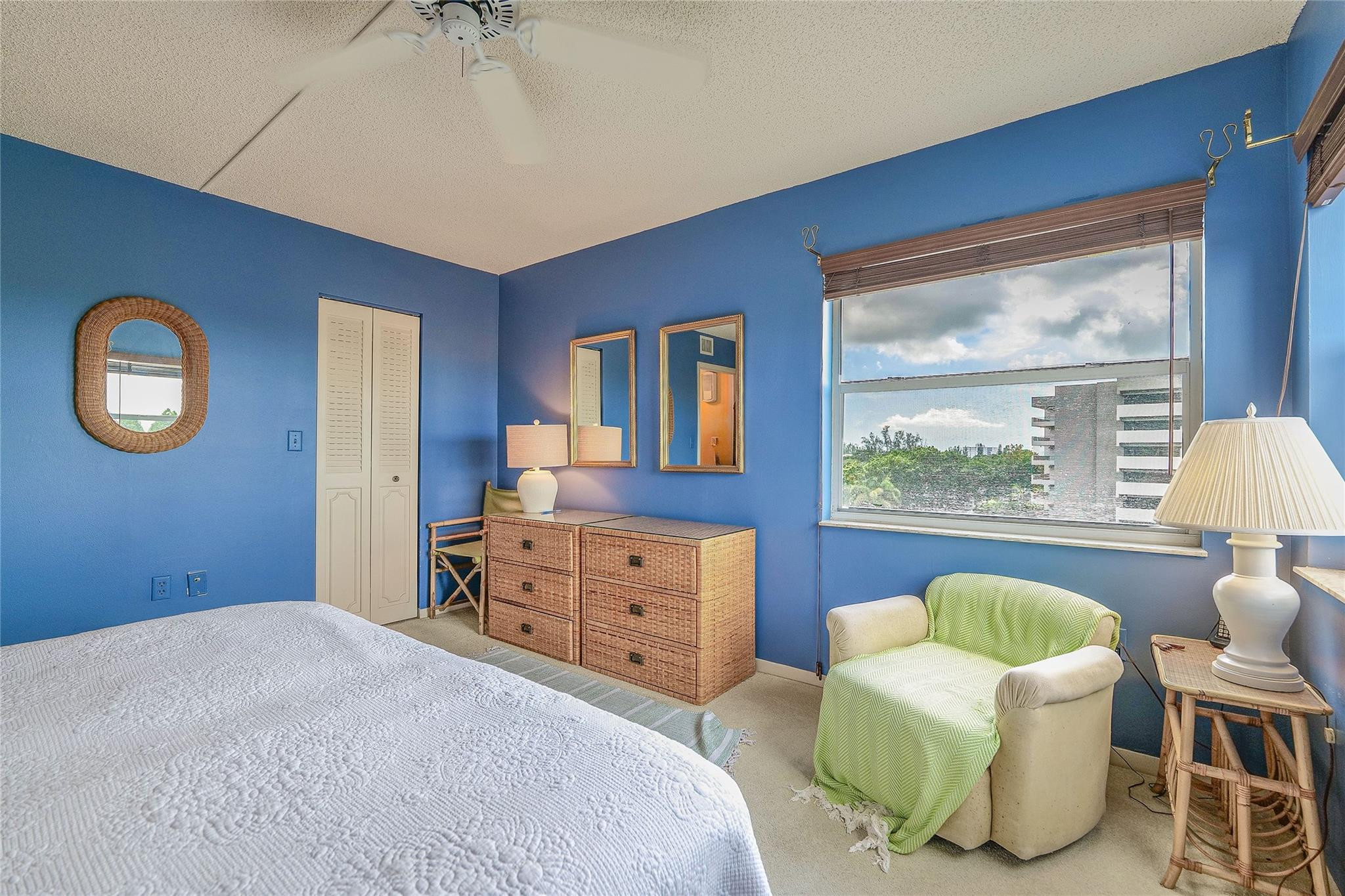 3930 Inverrary Boulevard, Unit 608D Lauderhill, FL 33319 - Photo 33 of 65 a bedroom with a bed and a dresser next to a window