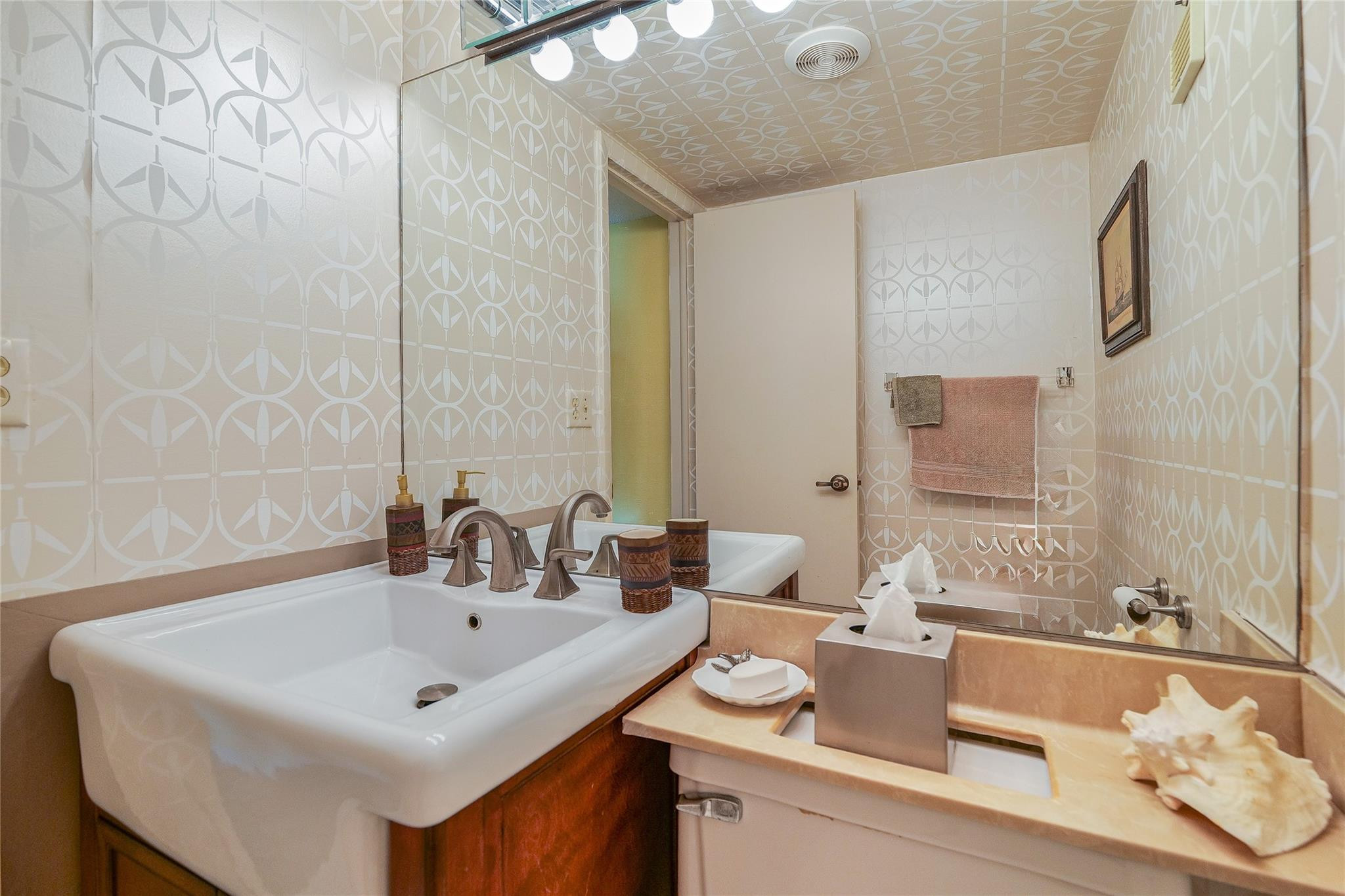 3930 Inverrary Boulevard, Unit 608D Lauderhill, FL 33319 - Photo 35 of 65 a bathroom with a sink and a mirror