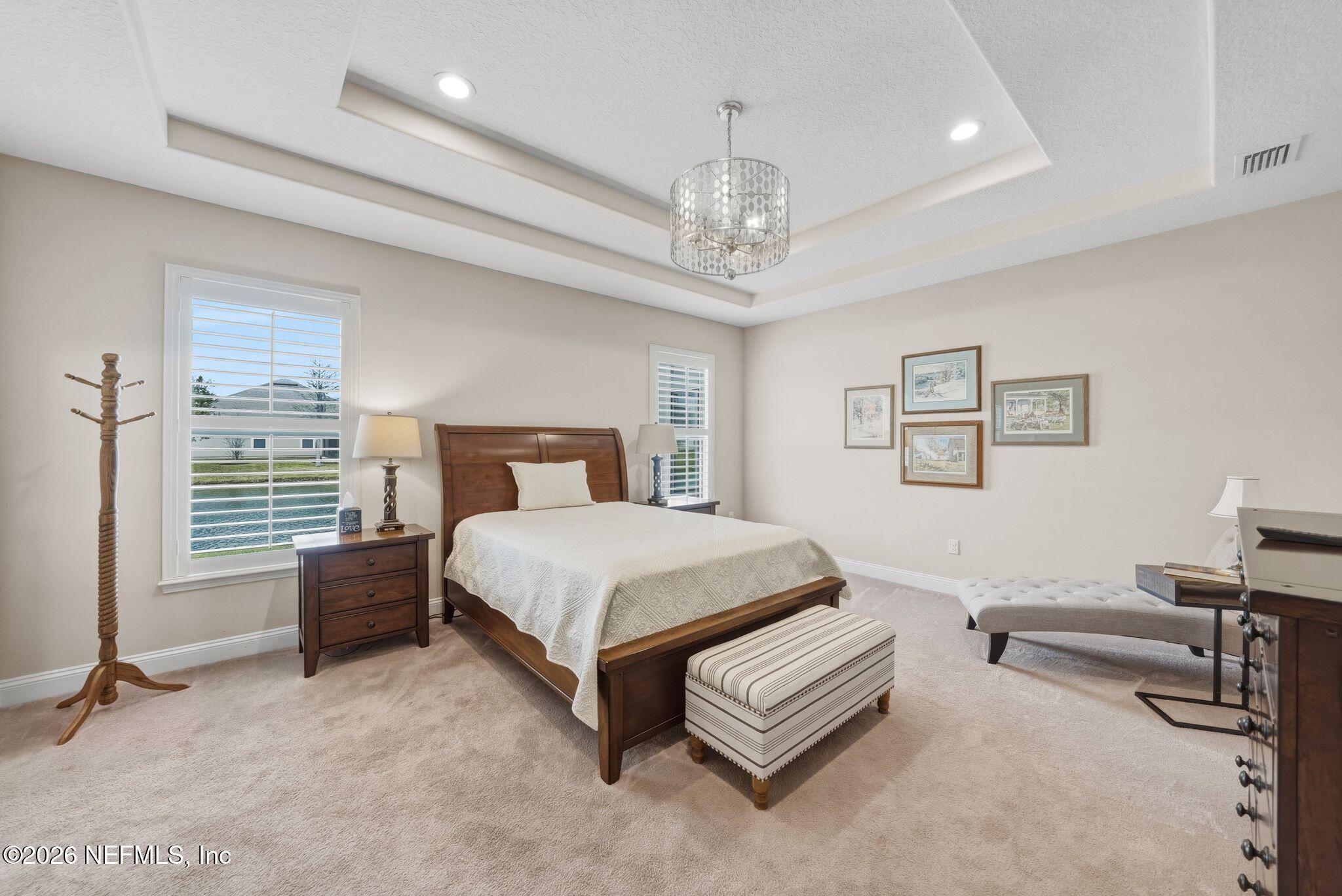 334 Athens Drive St. Augustine, FL 32092 - Photo 17 of 57 a bedroom with a bed furniture and a chandelier