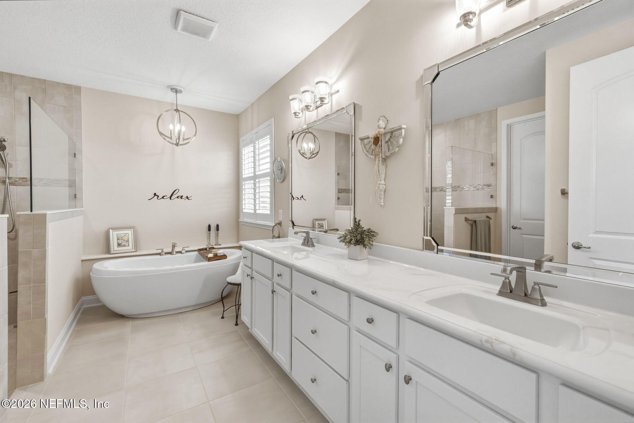 334 Athens Drive St. Augustine, FL 32092 - Photo 18 of 57 a bathroom with a granite countertop sink mirror bathtub and double