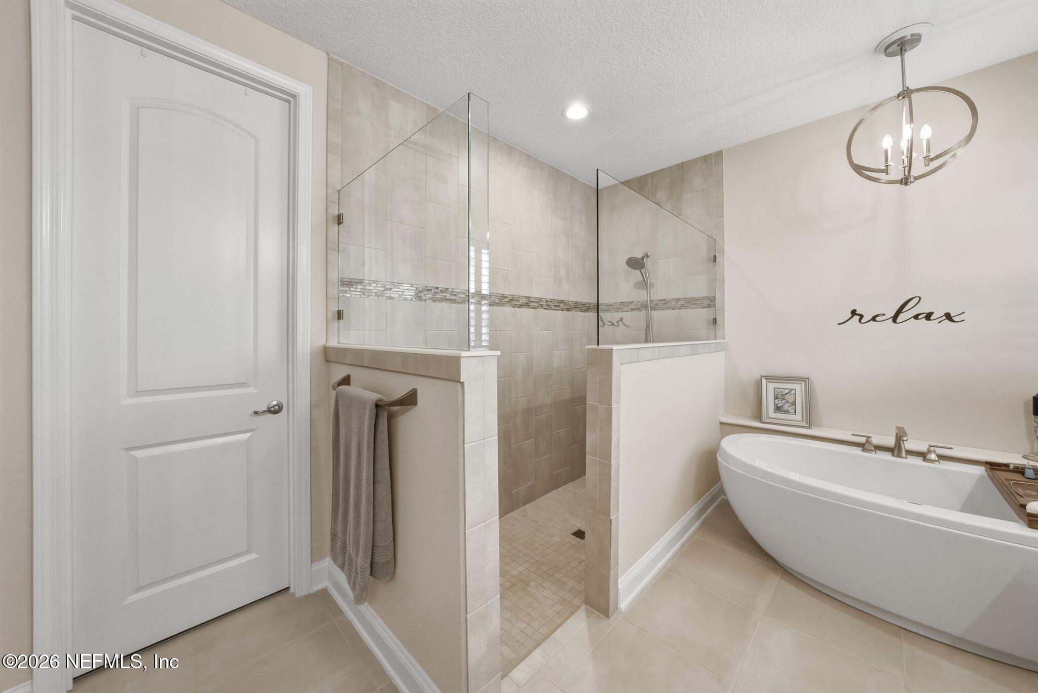 334 Athens Drive St. Augustine, FL 32092 - Photo 19 of 57 a bathroom with a bathtub and a shower