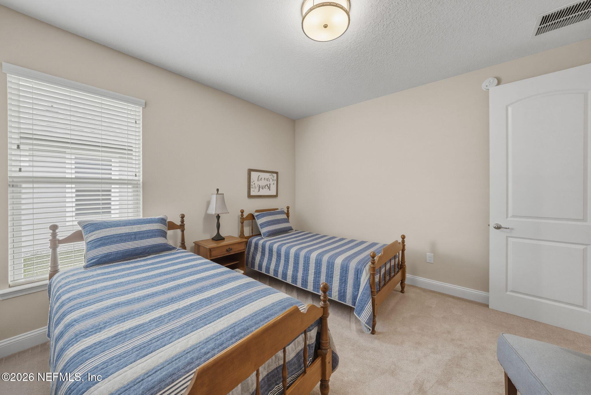 334 Athens Drive St. Augustine, FL 32092 - Photo 27 of 57 a bedroom with two beds and a window